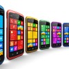 Mobility and telecommunication technology concept: group of modern color smartphones or mobile phones with colorful touchscreen interface isolated on white background